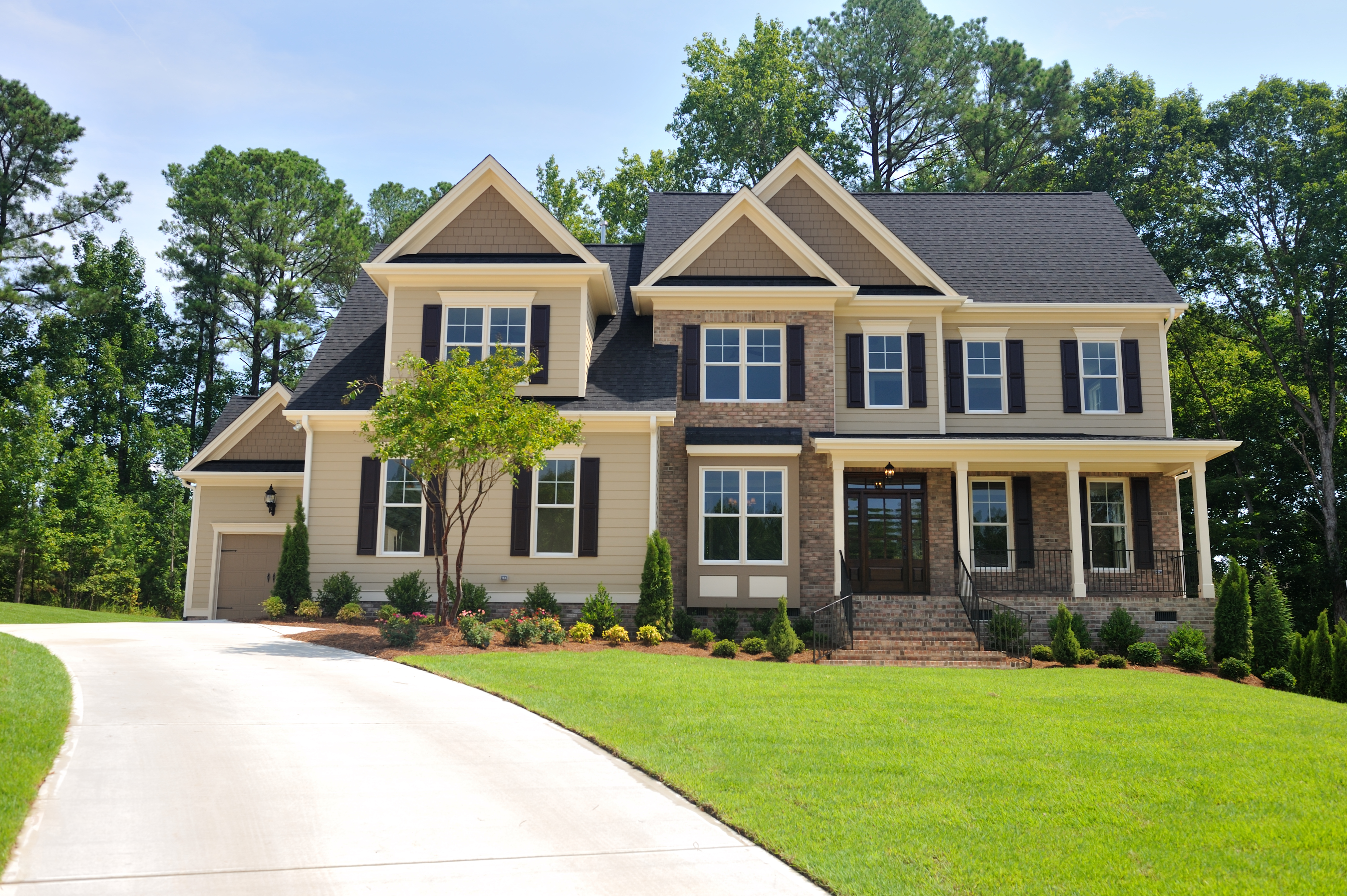 brown house with curved driveway