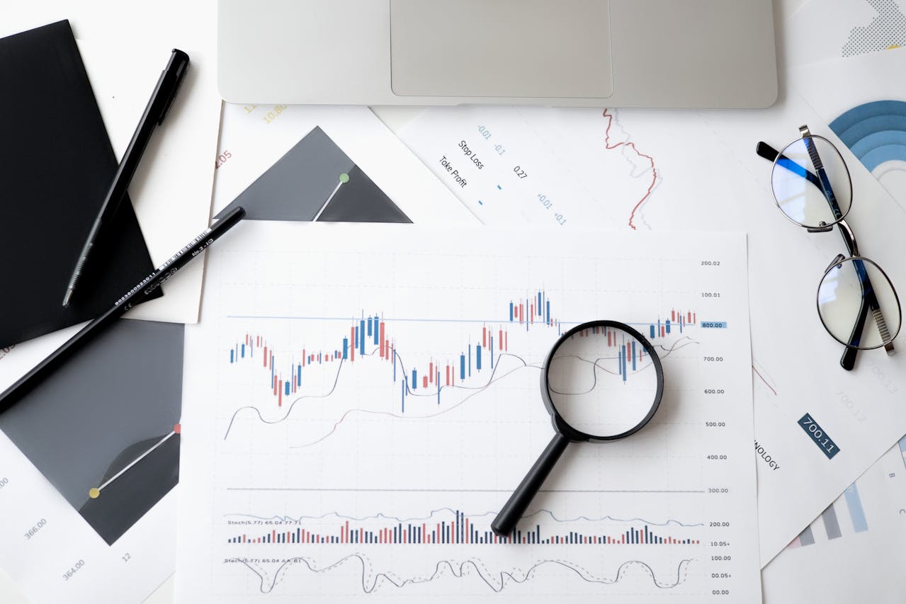graphs showing the market with magnifying glass over top